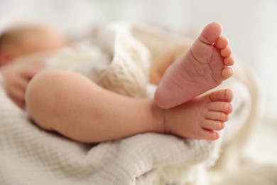 Photo of Cute newborn child lying in baby nest indoors, closeup