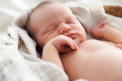 Photo of Cute newborn child sleeping in baby nest indoors