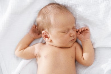 Photo of Cute newborn baby sleeping on bed, top view