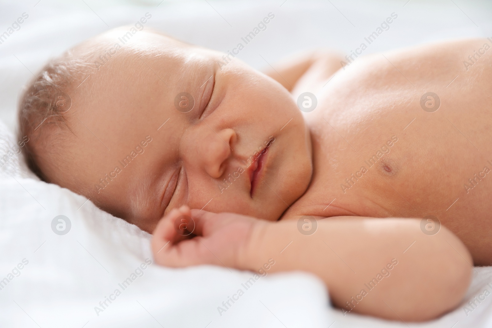 Cute newborn baby sleeping on bed indoors Photo of Cute newborn baby sleeping on bed indoors