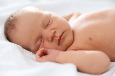 Photo of Cute newborn baby sleeping on bed indoors