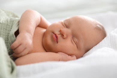 Photo of Cute newborn baby sleeping on bed indoors