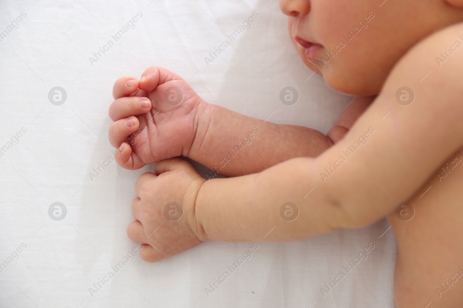 Cute newborn baby lying on bed, top view Photo of Cute newborn baby lying on bed, top view