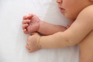 Photo of Cute newborn baby lying on bed, top view
