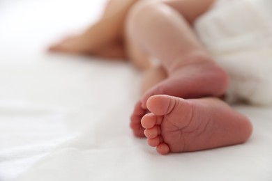 Photo of Cute newborn baby lying on bed, closeup. Space for text