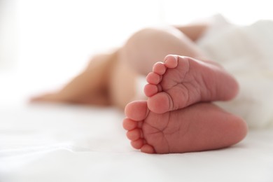 Photo of Cute newborn baby lying on bed, closeup. Space for text