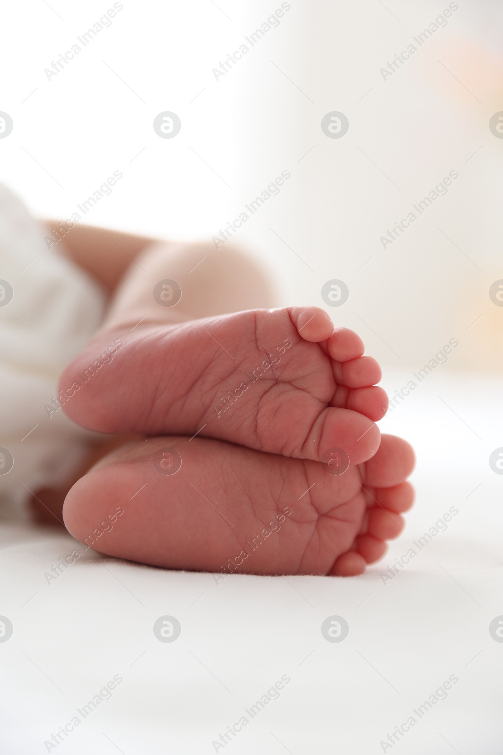 Cute newborn baby lying on bed, closeup Photo of Cute newborn baby lying on bed, closeup