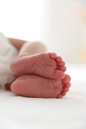 Photo of Cute newborn baby lying on bed, closeup
