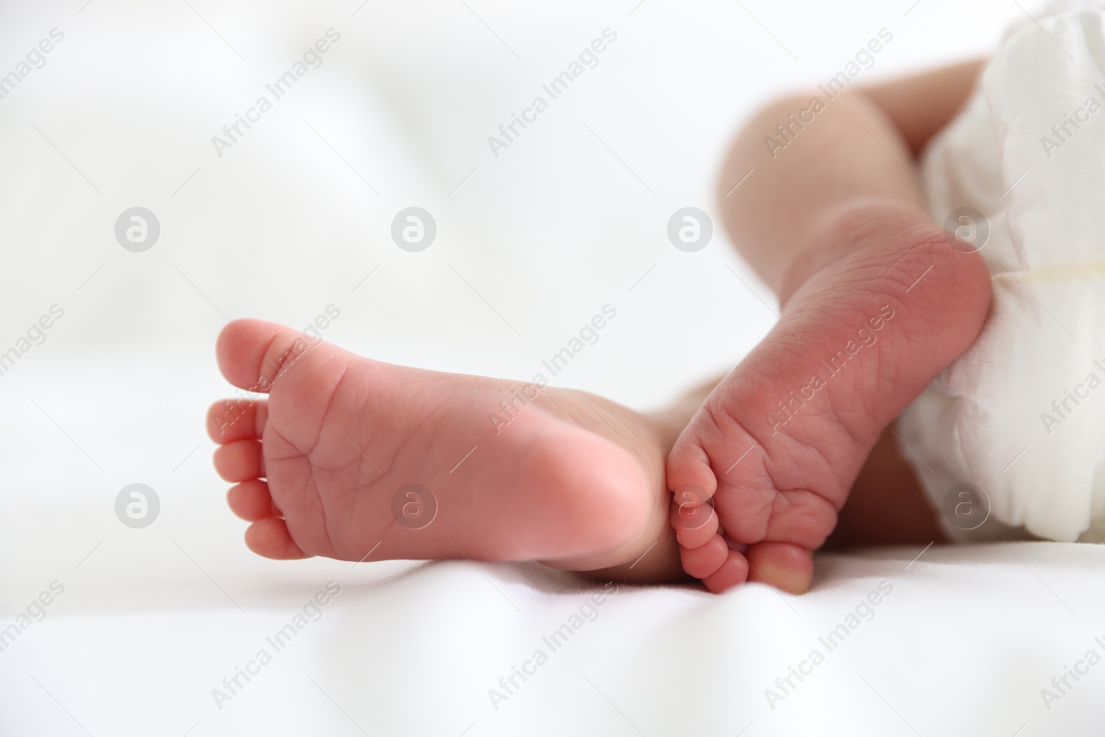 Cute newborn baby lying on bed, closeup Photo of Cute newborn baby lying on bed, closeup