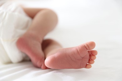 Photo of Cute newborn baby lying on bed, closeup