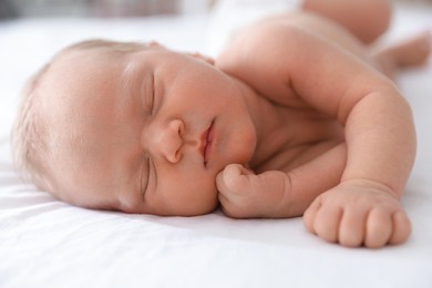 Photo of Cute newborn baby sleeping on bed indoors
