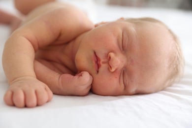 Photo of Cute newborn baby sleeping on bed indoors