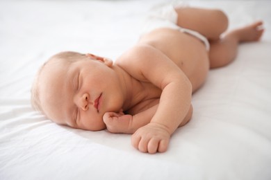 Photo of Cute newborn baby sleeping on bed indoors
