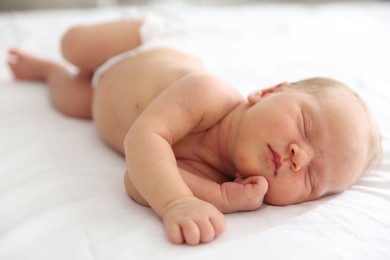 Photo of Cute newborn baby sleeping on bed indoors