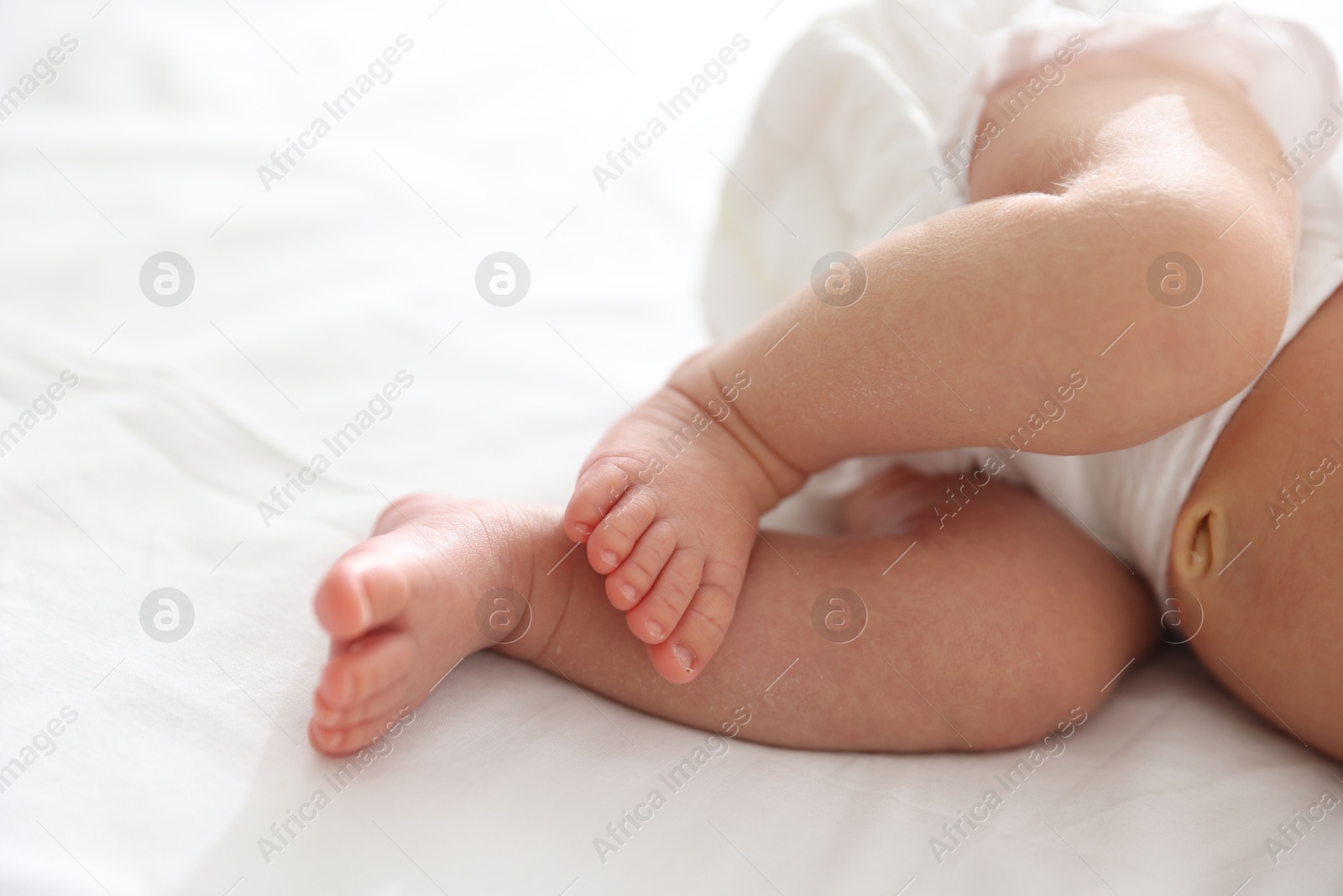 Cute newborn baby lying on bed, closeup Photo of Cute newborn baby lying on bed, closeup