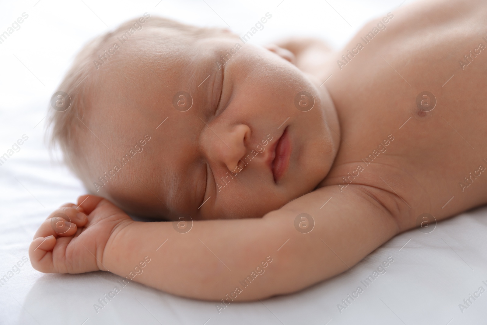 Cute newborn baby sleeping on bed indoors, closeup Photo of Cute newborn baby sleeping on bed indoors, closeup