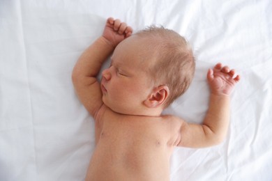 Photo of Cute newborn baby sleeping on bed, top view