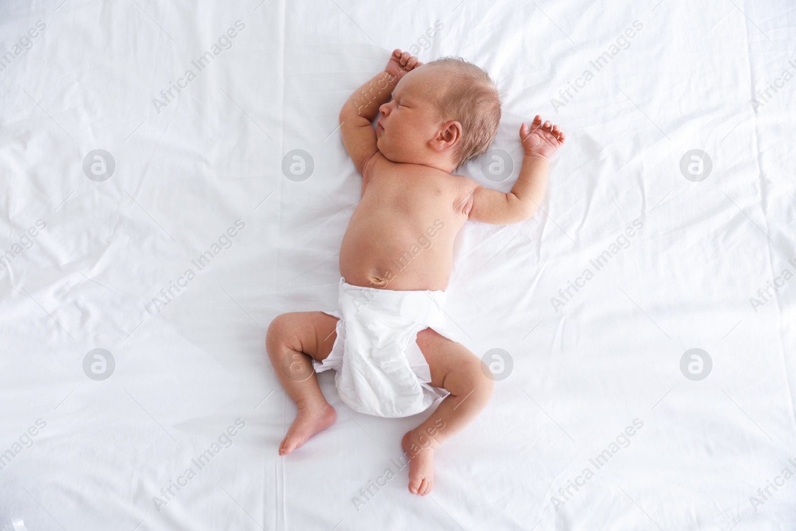 Cute newborn baby sleeping on bed, top view Photo of Cute newborn baby sleeping on bed, top view