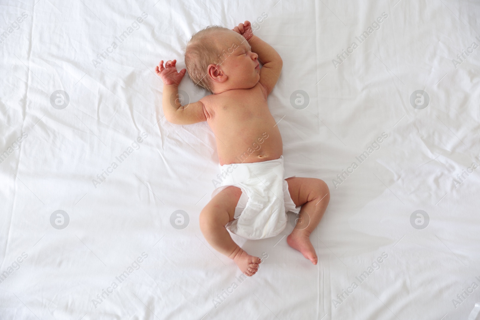 Cute newborn baby sleeping on bed, top view Photo of Cute newborn baby sleeping on bed, top view
