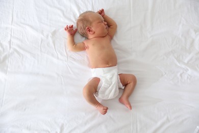 Photo of Cute newborn baby sleeping on bed, top view
