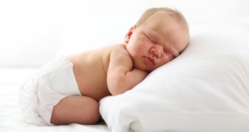 Photo of Cute newborn baby sleeping on bed indoors