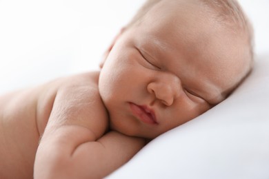 Photo of Cute newborn baby sleeping on pillow indoors