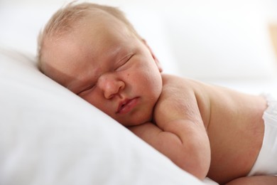 Photo of Cute newborn baby sleeping on pillow indoors