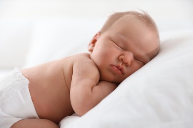 Photo of Cute newborn baby sleeping on pillow indoors