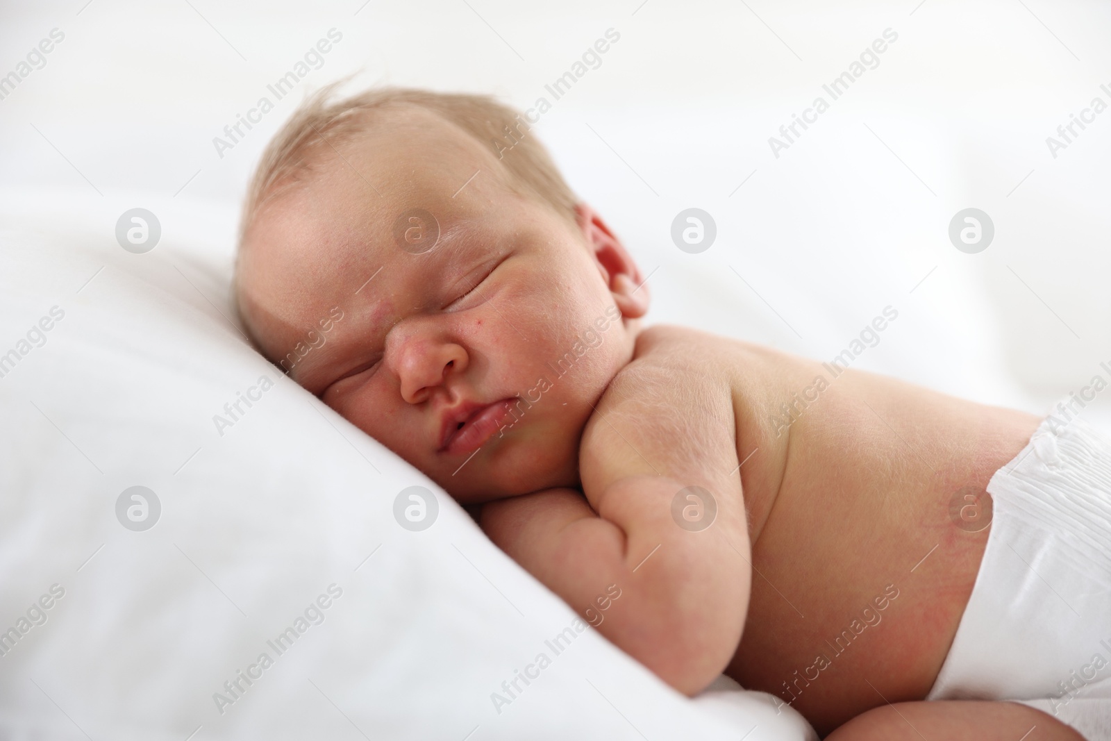 Cute newborn baby sleeping on pillow indoors Photo of Cute newborn baby sleeping on pillow indoors