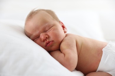 Photo of Cute newborn baby sleeping on pillow indoors