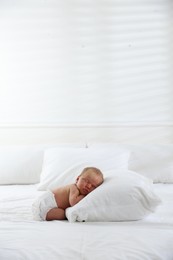 Photo of Cute newborn baby sleeping on bed indoors