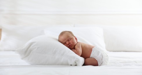 Photo of Cute newborn baby sleeping on bed indoors