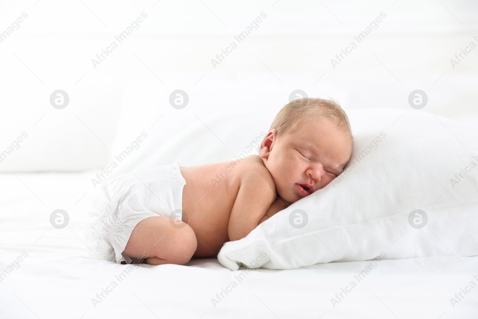 Cute newborn baby sleeping on bed indoors Photo of Cute newborn baby sleeping on bed indoors