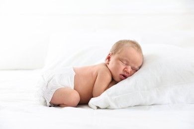 Photo of Cute newborn baby sleeping on bed indoors