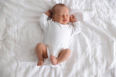 Photo of Cute newborn baby sleeping on bed, top view