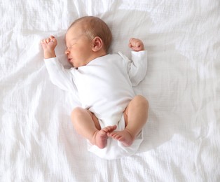Photo of Cute newborn baby sleeping on bed, top view