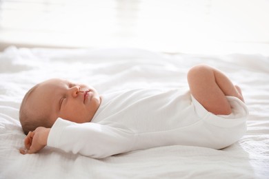 Photo of Cute newborn baby sleeping on bed indoors