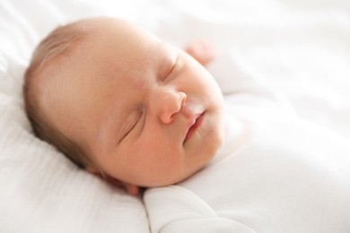 Photo of Cute newborn baby sleeping on bed indoors