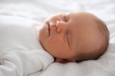 Photo of Cute newborn baby sleeping on bed indoors