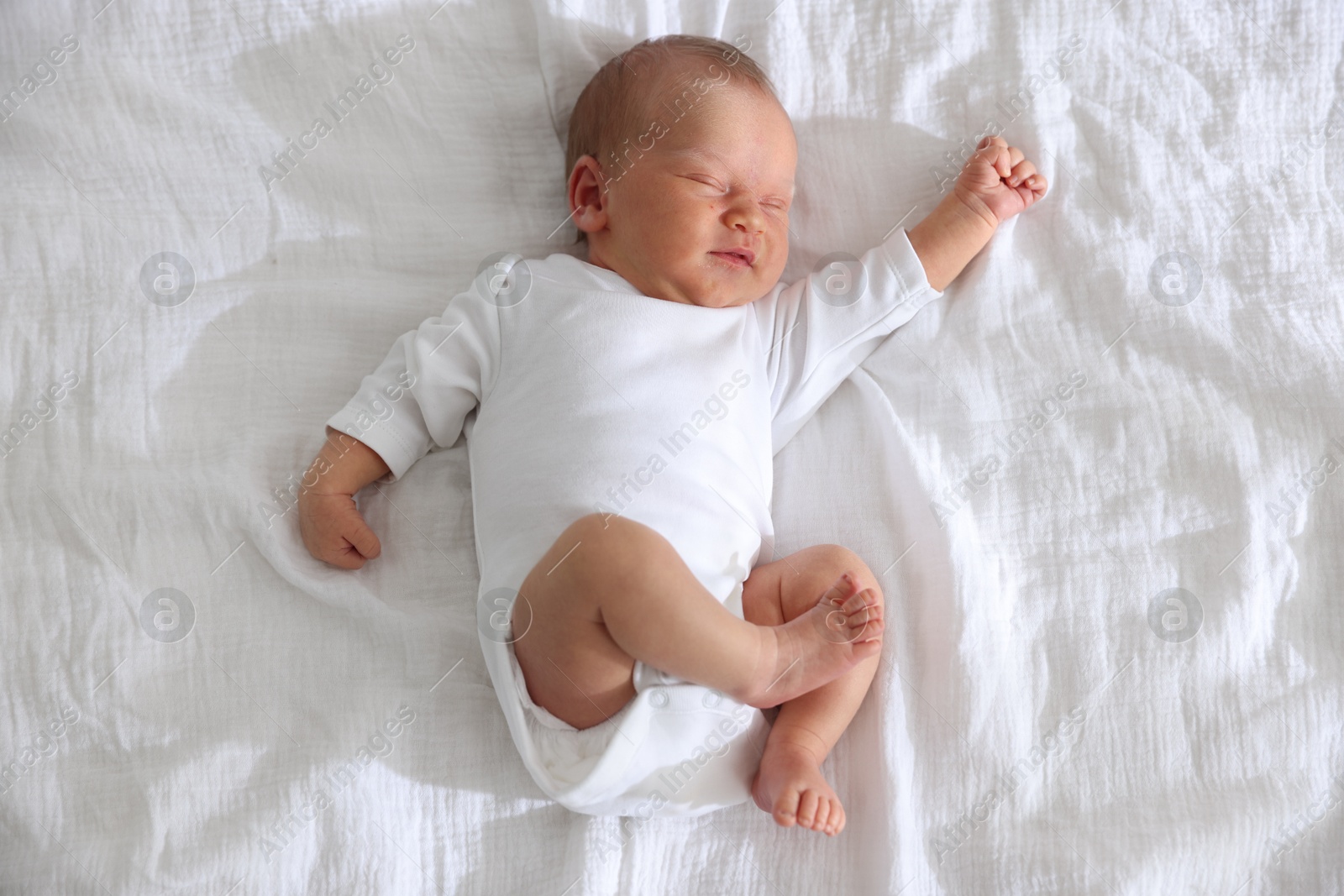Cute newborn baby sleeping on bed, top view Photo of Cute newborn baby sleeping on bed, top view