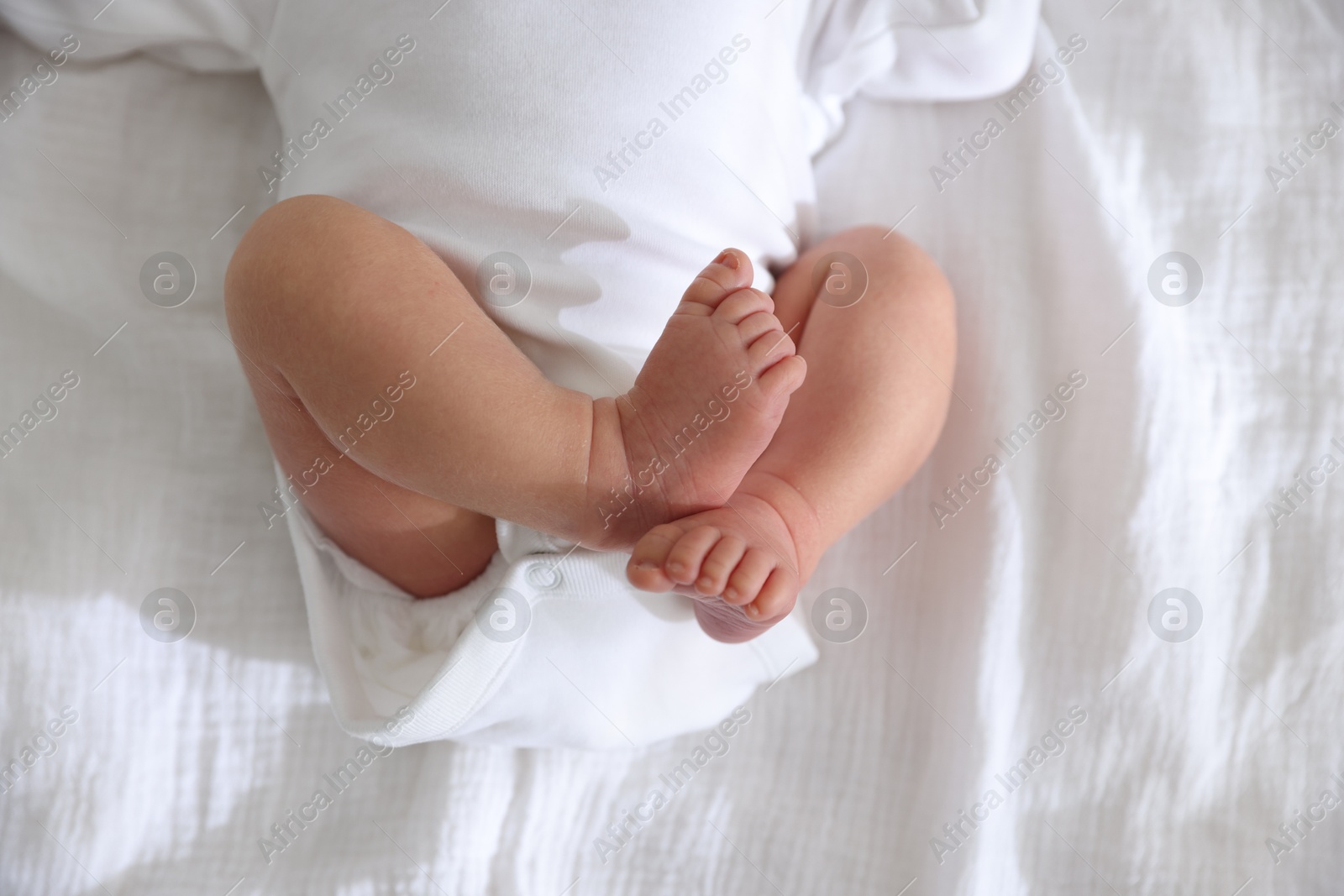 Cute newborn baby lying on bed, top view Photo of Cute newborn baby lying on bed, top view