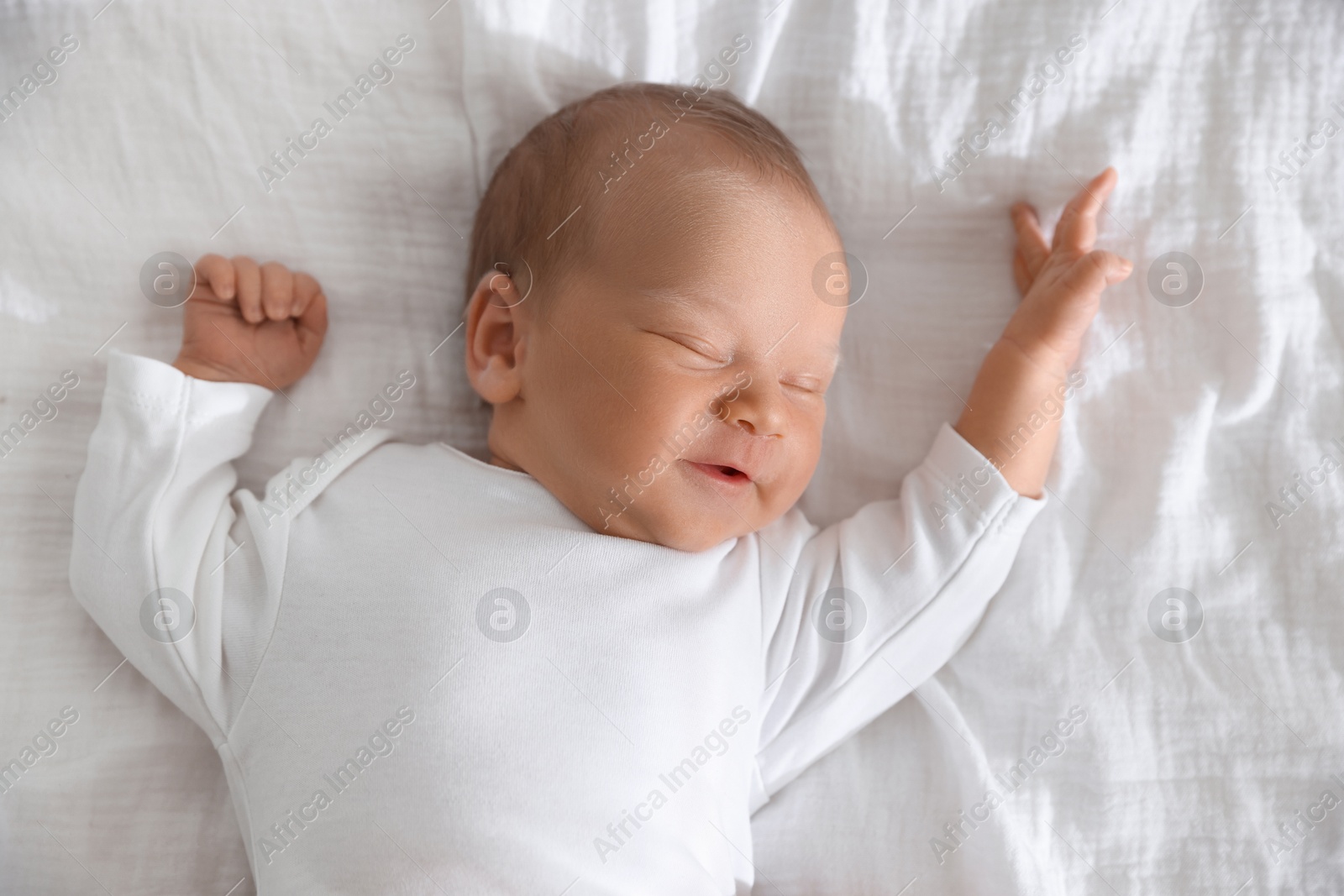 Cute newborn baby sleeping on bed, top view Photo of Cute newborn baby sleeping on bed, top view