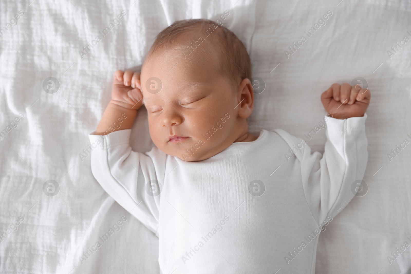 Photo of Cute newborn baby sleeping on bed, top view