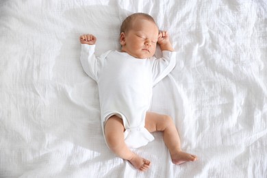 Photo of Cute newborn baby sleeping on bed, top view