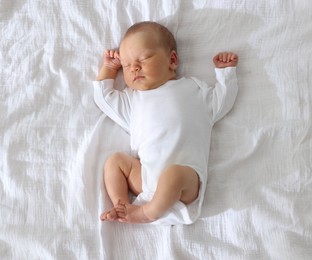 Photo of Cute newborn baby sleeping on bed, top view
