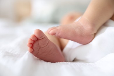 Photo of Cute newborn baby lying on bed, closeup