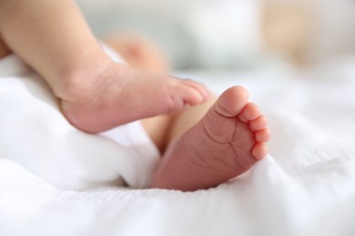 Photo of Cute newborn baby lying on bed, closeup
