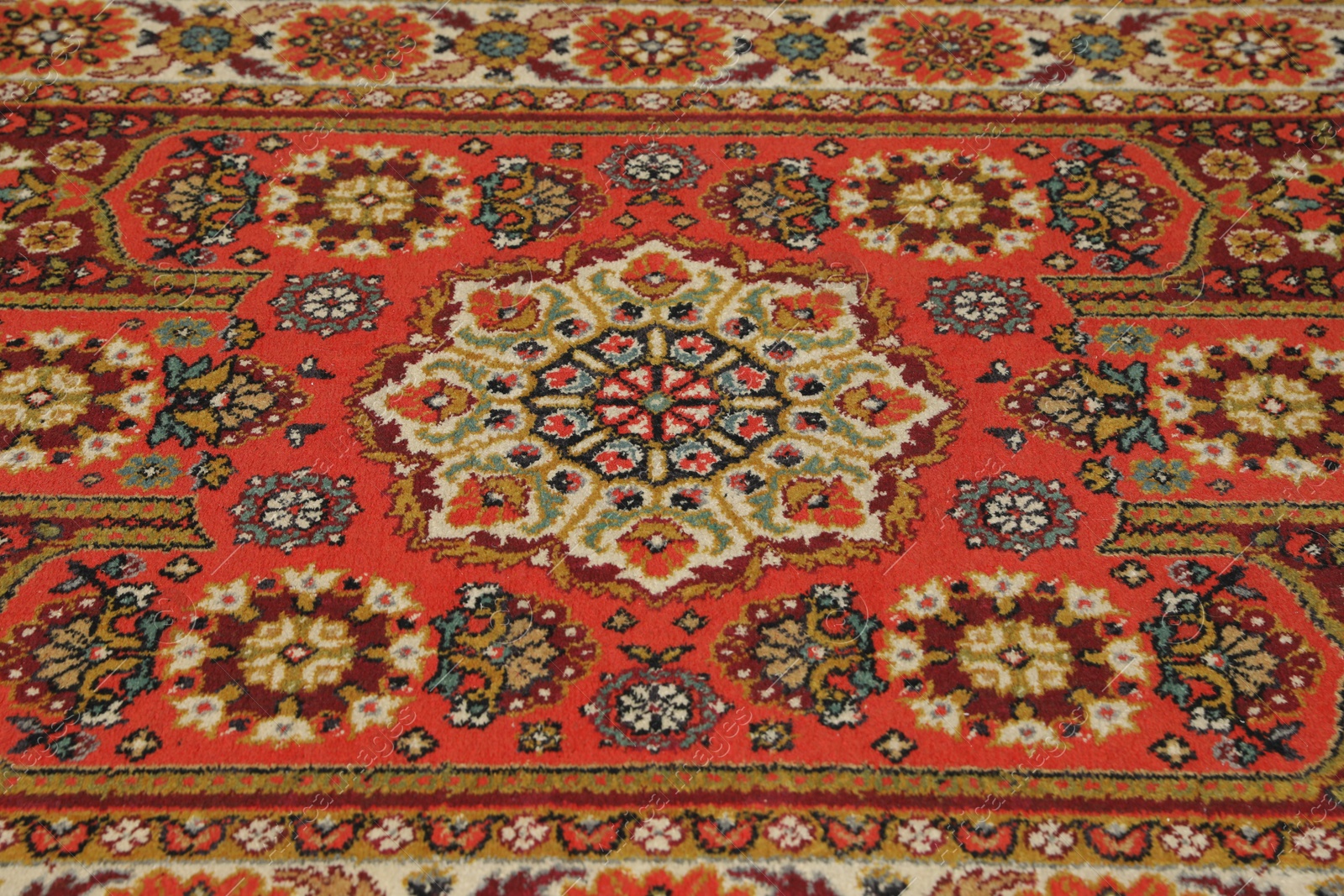 Photo of Soft red carpet with pattern, closeup. Used stuff