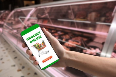 Image of Food delivery. Man using mobile phone app to order grocery online, closeup