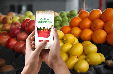 Image of Food delivery. Man using mobile phone app to order grocery online, closeup